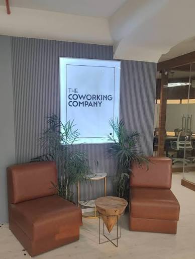 The Coworking Company reception with its brand signage